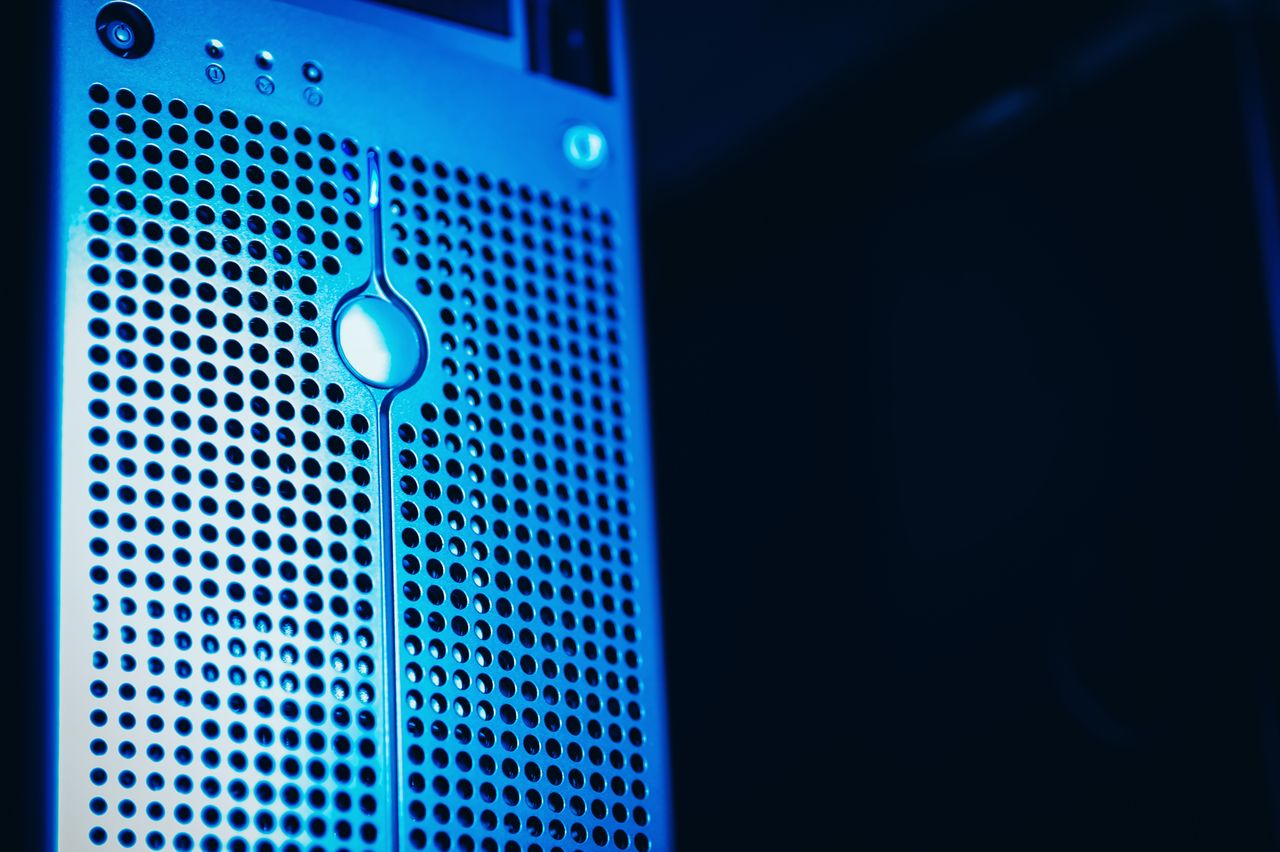 services-02 Modern server rack with blue lighting in a secure data center environment.